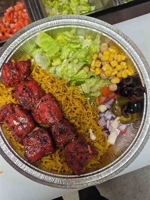 Charcoal-grilled chicken tikka over saffron basmati rice
