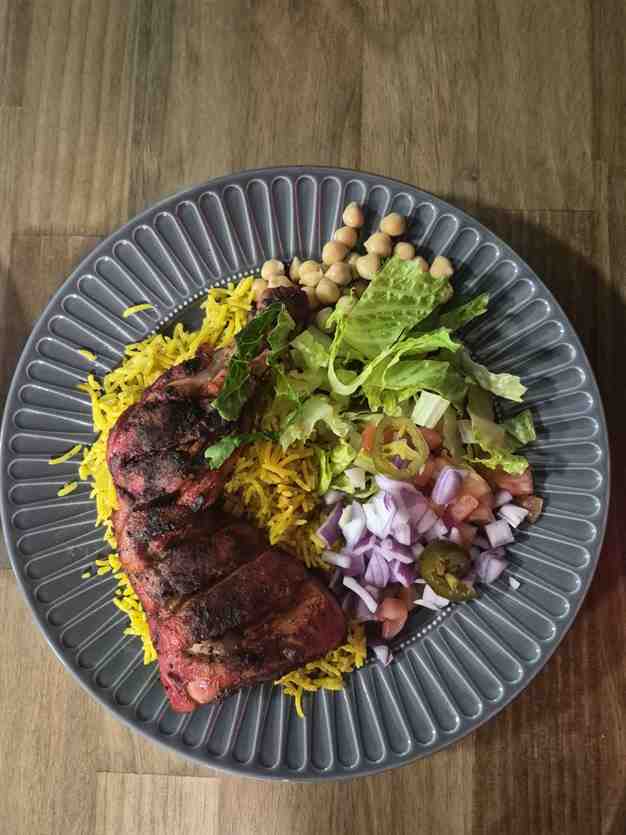 Fire-grilled halal lamb chops over saffron basmati rice at Gyro 9 in Richmond, TX